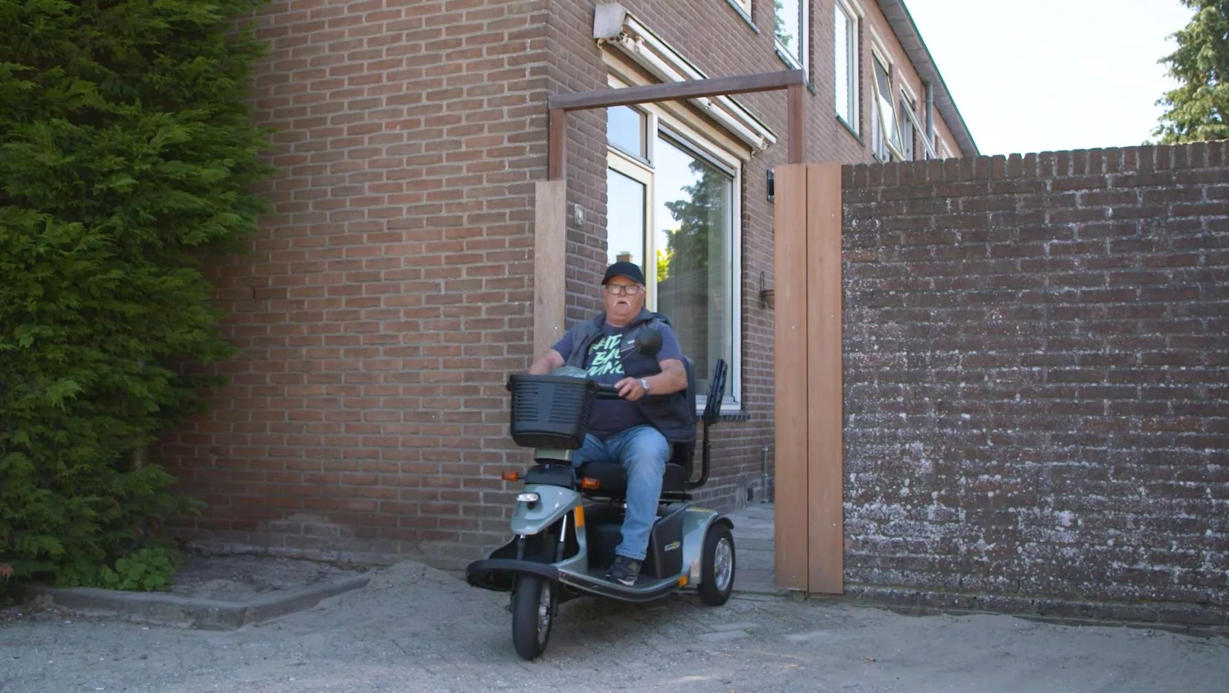 Scootmobiel uit tuin rijden